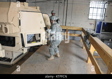 Sgt. 1st Class Theresa Barone-Lopez emerges from the Humvee rollover training  simulator on Feb. 25 at Camp Smith Training Site before as a group of 42nd Soldiers certify on the simulator as part of their pre-mobilization training before deploying to Guantanamo Bay, Cuba. Photo by Sgt. 1st class Steven Petibone, 42nd Infantry Division. Stock Photo