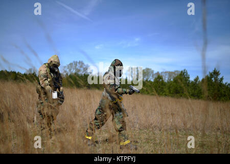 PERRY, GA - Air National Guard Emergency Managers search for radioactive material during a Global Dragon training event at the Guardian Center of Georgia on March 15, 2015.    During this day's training, airmen searched for material following a simulated aircraft crash in a deployed location. Students wore Mission Oriented Protective Posture (MOPP) 4 gear, and used Gieger Counters to search through an empty field for the lost material.   Global Dragon provides a refresher course for Airmen, allowing them to put their skills to use to identify live chemical, biological, radiological and nuclear Stock Photo