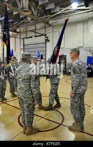 Outgoing Command Sgt. Maj. Mitchell Rucker hands the brigade colors to ...
