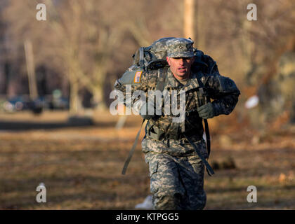 Pfc. Vincente Torres, a soldier with the 27th Infantry Brigade Combat Team, finishes the ruck march final event on the last day of the annual New York State Best Warrior Competition March 29, 2015, at Camp Smith, N.Y.  The ruck march event was also included as part of the testing for the German Armed Forces Proficiency Badge, requiring them to ruck 12 km. in under two hours. The competitors were given a chance to earn the badge for the first time in the Best Warrior competition.  The Best Warrior competitors represent each of New York's brigades after winning competitions at the company, batta Stock Photo