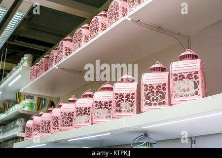 Close up several vintage pink candle lanterns on shelf in supermarket Stock Photo