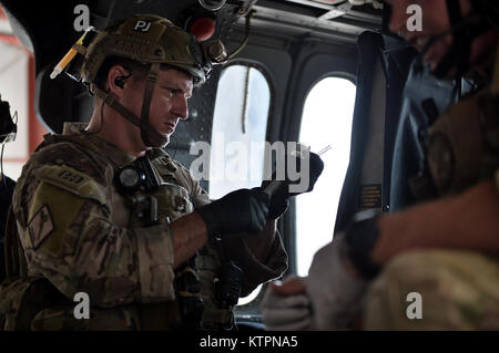 WESTHAMPTON BEACH, NY  - A Pararescue Jumper with the 103rd Rescue Squadron, 106th Rescue Wing practices placing an IV line into a patient during a mass casualty training with the Battlefield Air Targeting Man-Aided Knowledge System (BATMAN) at FS Gabreski ANG on August 25, 2015.  The BATMAN system is an Air Force research laboratory advanced technology demostration program that develops enhanced capabilities for battlefield airmen. The program applies an airmen-centric design approach to all its research and development efforts to maximize the airmen's mission effectiveness and efficiency.    Stock Photo