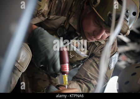 WESTHAMPTON BEACH, NY  - A Pararescue Jumper with the 103rd Rescue Squadron, 106th Rescue Wing practices placing an IV line into a patient during a mass casualty training with the Battlefield Air Targeting Man-Aided Knowledge System (BATMAN) at FS Gabreski ANG on August 25, 2015.  The BATMAN system is an Air Force research laboratory advanced technology demostration program that develops enhanced capabilities for battlefield airmen. The program applies an airmen-centric design approach to all its research and development efforts to maximize the airmen's mission effectiveness and efficiency.    Stock Photo