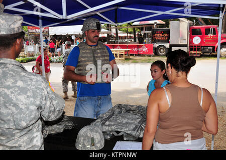 SARATOGA -- Local New York National Guard recruiters talk to attendees at the Saratoga race track on Sept. 2 during Military Appreciation Day. Photo by Sgt. 1st Class Steven Petibone, 42nd Infantry Division. Stock Photo