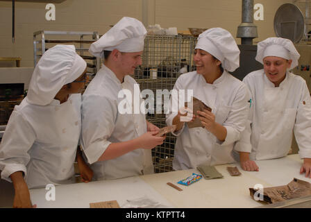 Student chefs discuss how to use MRE food components to prepare a meal at a Boards of Cooperative Educational Services (BOCES) vocational education facility in Goshen, N.Y. on Dec. 4, 2015. The students prepared meals with MREs as part of a New York Army National Guard educational challenge designed to test their skills and familiarize them with Army careers. The students are, from left: Brianna Carnegie, a junior at Monroe Woodbury High School; Michael Granucci, a junior at Goshen High School; Jocelyn Gavilanez, a junior at Chester High School; and Blake Post, a junior at Minisink Valley High Stock Photo