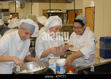 Student chefs share some laughs as they use MRE food components to prepare a meal at the Orange County Boards of Cooperative Educational Services (BOCES) vocational education facility in Goshen, N.Y. on Dec. 4, 2015. The students prepared meals with MREs as part of a New York Army National Guard educational challenge designed to test their skills and familiarize them with Army careers. The students are, from left: Heriberto Ayala, a junior at Pine Bush High School;  Anna Gil, a senior at Goshen High School; Jeremy Nieves, a junior at Middletown High School. (U.S. Army National Guard photo by M Stock Photo