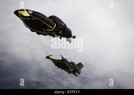 HOMESTEAD AIR RESERVE BASE, FL - Staff Sgt. John Lopez and Staff Sgt. Travis Downing, both members of the Army's Golden Knights demonstration team, conduct a training jump over Homestead Air Reserve Base on January 19, 2016.  (US Air National Guard / Staff Sgt. Christopher S. Muncy / released) Stock Photo