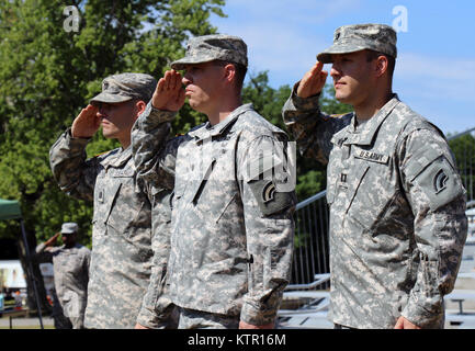 CORTLANDT MANOR, N.Y. -- Capt. Matthew White (left), Lt. Col. Mark Frank (middle) and Capt. Ryan Brountas (right) salute as the National Anthem plays during the New York Army National Guard's 42nd Division Signal Company 's change-of-command ceremony held at Camp Smith Training Site here on June 24. During the ceremony, Frank, the 42nd Infantry Division’s Headquarters and Headquarters Battalion commander, passed the company colors from Brountas, the outgoing commander, to White, signifying White's assumption of command. Brountas is going on to become the signal officer for the New York Army Na Stock Photo