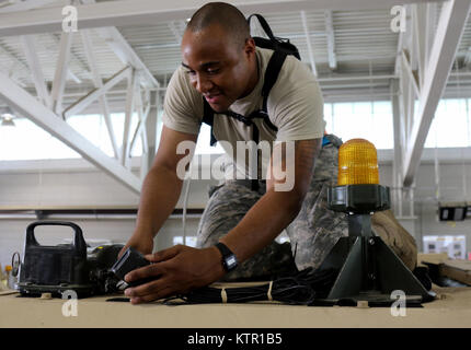 Sgt. Holden Davenport from the New York Army National Guard's 1st Infantry Brigade Combat Team, 69th Infantry Battalion, Headquarters Headquarters Company, is adjusting the Multiple Integrated Laser Engagement System to an armored tactical at Fort Polk, La.   More than 3,000 New York Army National Guard Soldiers deployed to Fort Polk, Louisiana for a three week exercise at the Army’s Joint Readiness Training Center, July 9-30, 2016. Stock Photo