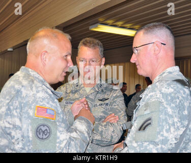 New York Air National Guard Maj. Gen. Anthony German, the New York National Guard Adjutant General (center) and New York Army National Guard Commander Brig. Gen. Raymond Shields (left) discuss the 27th Infantry Brigade Combat Teams training with Brig. Gen. Francis McGinn, 42nd Infantry Division Deputy Commander at the Army’s Joint Readiness Training Center, Fort Polk, Louisiana, Saturday, July 16, 2016. Approximately 3,000 Soldiers from New York joined 2,000 other state Army National Guard units, active Army and Army Reserve troops as part of the 27th Infantry Brigade Combat Team task force.   Stock Photo