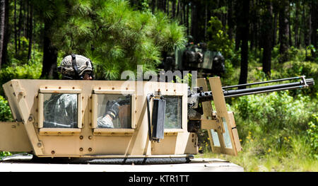 A Soldier with the Massachusetts Army National Guard's 1st Brigade, 182nd Infantry takes aims with a .50-caliber machine gun at the Army’s Joint Readiness Training Center, Fort Polk, La., July 18, 2016. The infantrymen joined more than 5,000 Soldiers from other state Army National Guard units, active Army and Army Reserve troops as part of the 27th Infantry Brigade Combat Team task force.  The Soldiers will hone their skills and practice integrating combat operations ranging from infantry troops engaging in close combat with the enemy to artillery and air strikes, July 9-30, 2016. (U.S. Army N Stock Photo