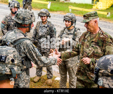 Connecticut Army National Guard Brig. Gen. Mark Russo, Assistant Adjutant General,  presents a challenge coin in recognition of excellence to Sgt. Michael Boscarin, a crew chief assigned to Company C, 3rd Battalion, 142nd Aviation Regiment  based in Windsor Locks, Conn., during a visit to the Army's Joint Readiness Training Center, Fort Polk, La., Monday, July 18, 2016. The 3-142nd Aviation joined more than 5,000 Soldiers from other state Army National Guard units, active Army and Army Reserve troops as part of the 27th Infantry Brigade Combat Team task force, July 9-30, 2016. U.S. Army Nation Stock Photo