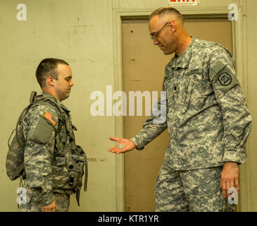 Lt. Col. Paul Groteluschen, commander of the 109th Medical Battalion, Iowa Army National Guard, presents a challenge coin to a Soldier of the 209th Area Support Medical Company for exemplary service during the unit's Joint Readiness Training Center (JRTC) rotation July 19, 2016, in Fort Polk, La.  The Iowa medical personnel joined more than 5,000 Soldiers from other state Army National Guard units, active Army and Army Reserve troops as part of the 27th Infantry Brigade Combat Team task force.  The Soldiers will hone their skills and practice integrating combat operations ranging from infantry Stock Photo