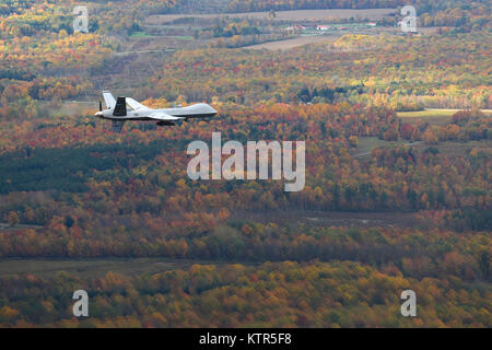 Syracuse, NY – A remotely piloted MQ-9 Reaper operated by the New York Air National Guard’s 174th Attack Wing flies a routine training mission over Central New York on October 23, 2016. The Civil Air Patrol provides chase plane operations for the MQ-9, to and from restricted air space, to meet FAA see-and-avoid requirements of remotely piloted aircraft (RPA). (U.S. Air National Guard Photo by Master Sgt. Eric Miller/released) Stock Photo
