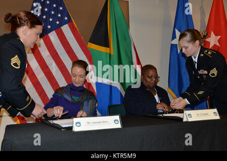 Bilateral Defense Committee Co-Chairs Amanda Dory, U.S. Deputy Assistant Secretary of Defense for African Affairs, and her counterpart, Dr. Thobelile Gamade, Chief of South African Defense Policy, Strategy and Planning, sign the executive summaries of the 2016 meeting October 26 at the New York State Military Museum in Saratoga Springs, N.Y. The senior leaders of the South African National Defense Forces discussed training and exercise opportunities for 2017 during the U.S. and Republic of South Africa. The meeting was hosted by the New York National Guard, a National Guard Bureau state partne Stock Photo