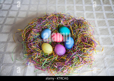 Colorful Easter eggs in an Easter basket, New Jersey, USA, US, unconventional Easter bonnet concept wreath Stock Photo