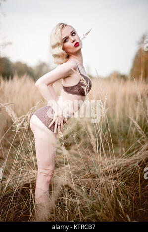 Pin up girl wearing vintage 1950's dress with frilly 