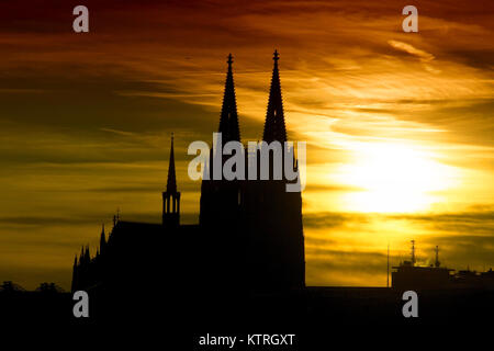 Silhouette of world heritage site Cologne Cathedral at sunset with dramatic sky. At the famous cathedral is the shrine of the holy three kings. Stock Photo