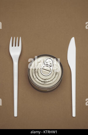 unopened tin can and plastic cutlery Stock Photo