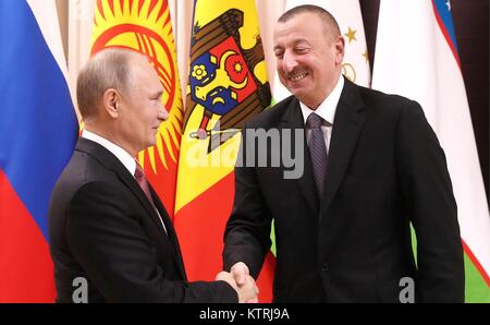 Russian President Vladimir Putin welcomes Azerbaijan President Ilham Aliyev before the start of an informal meeting of the Commonwealth of Independent States leaders at the Novo-Ogaryovo residence December 26, 2017 outside Moscow, Russia. Stock Photo