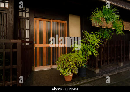 Japanese tea house in Gion, Kyoto built in a mix of modern and traditional architectural style, exterior decorated with potted exotic plants. Gion dis Stock Photo