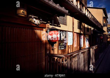 Traditional Japanese tea house Tama with a red lantern by the entrance door. Hanamikoji Dori street in Gion district in morning light. Hanami-koji, Gi Stock Photo