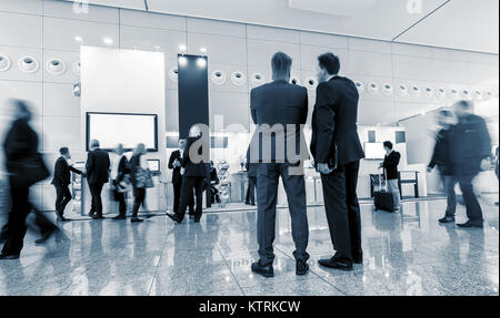 Trade Fair Stand with Blurred business people in motion Stock Photo
