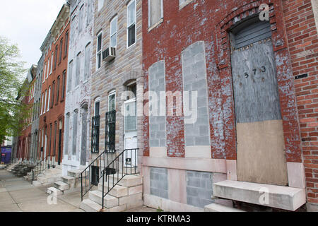 A boarded up row home on Pennsylvania Avenue in Baltimore City, MD Stock Photo