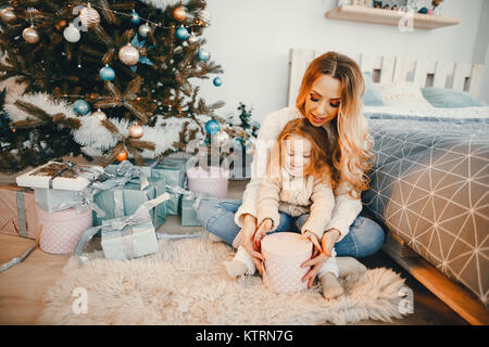 mommy and daughter opening gifts Stock Photo