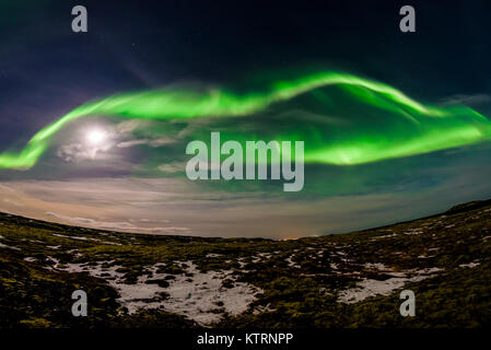 Spectacular Aurora Borealis. Amazing dancing green and pink northern lights above a lava field near Reykjavik, Iceland. Stock Photo