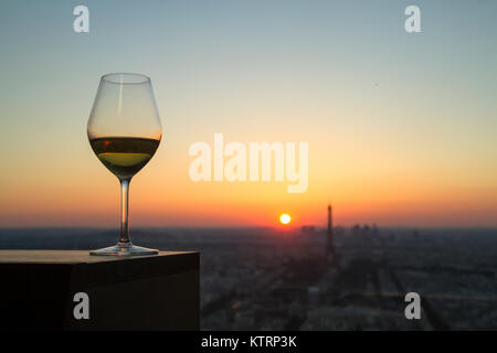 white Wine glass with view on paris city at sunset Stock Photo