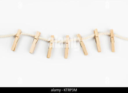 Clothes clips on a rope isolated on white background - loundry peg on string isolated Stock Photo