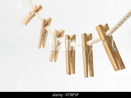 Clothes clips on a rope isolated on white background - loundry peg on string isolated Stock Photo