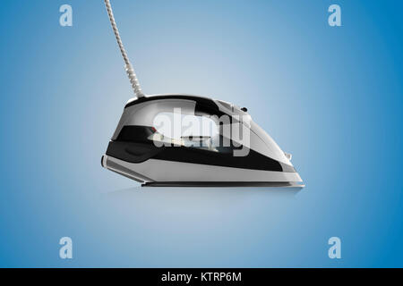 side view of Modern steam iron isolated on blue background Stock Photo