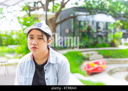unhappy portrait cute young innocent asian teen expression boring Stock Photo