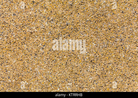 Close-up beige colored sandy stucco texture background. Stock Photo