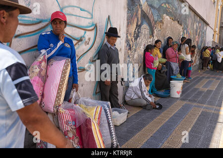 Otavalo, Ecuador-December 23, 2017:people cooling down in the shade on a hot day Stock Photo