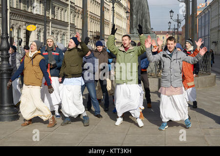 12.03.2017.Russia.Saint-Petersburg.On the street gathered followers of Lord Krishna.Young people are dancing,collecting alms and distributing sweets. Stock Photo