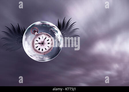 Stopwatch inside a floating soap bubble with wings Stock Photo