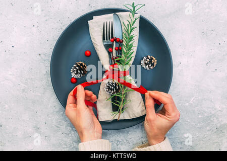 Woman's hands preparing a festive place setting Stock Photo