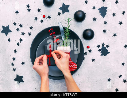 Woman's hands preparing a festive place setting Stock Photo