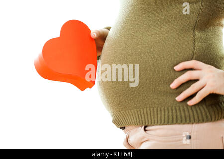 Pregnant woman holding red heart shaped box Stock Photo