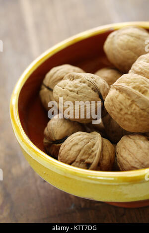 whole walnuts in bowl Stock Photo
