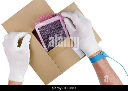 The technician in antistatic gloves takes out a tablet spare part from the industrial cardboard package. Isolated on white top view studio concept Stock Photo