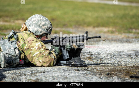 U.S. Army Spc. Courtney Natal zeroes her weapon before shooting a weapon qualification during the New York Army National Guard Best Warrior Competition at Camp Smith Training Site March 30, 2017. The Best Warrior competitors represent each of New York's brigades after winning competitions at the company, battalion, and brigade levels. At the state level they are tested on their physical fitness, military knowledge, endurance, marksmanship, and land navigation skills. The two winners of the competition, one junior enlisted and one NCO, advance to compete at the regional level later this year. ( Stock Photo