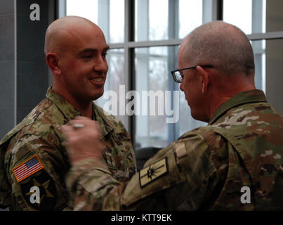 Chief Warrant Officer 2 Matthew Starr  is congratulated following his promotion ceremony on March 31, 2017 at New York National Guard headquarters in Latham, N.Y. Starr works in the New York National Guard federal personnel office. ( U.S. Army National Guard photo by Eric Durr) Stock Photo