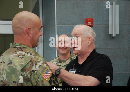 Chief Warrant Officer 2 Matthew Starr  is congratulated following his promotion ceremony on March 31, 2017 at New York National Guard headquarters in Latham, N.Y. Starr works in the New York National Guard federal personnel office. ( U.S. Army National Guard photo by Eric Durr) Stock Photo