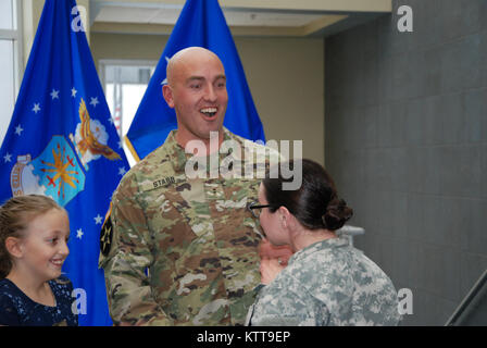 Chief Warrant Officer 2 Matthew Starr  is congratulated following his promotion ceremony on March 31, 2017 at New York National Guard headquarters in Latham, N.Y. Starr works in the New York National Guard federal personnel office. ( U.S. Army National Guard photo by Eric Durr) Stock Photo