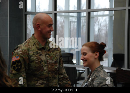 Chief Warrant Officer 2 Matthew Starr  is congratulated following his promotion ceremony on March 31, 2017 at New York National Guard headquarters in Latham, N.Y. Starr works in the New York National Guard federal personnel office. ( U.S. Army National Guard photo by Eric Durr) Stock Photo