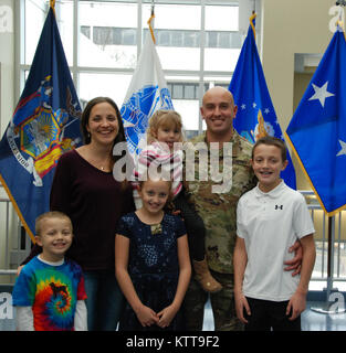 The family of Chief Warrant Officer 2 Matthew Starr following his promotion on March 31, 2017 at New York National Guard headquarters in Latham, N.Y. Pictured are, from right, Ethan, Jenny , Maya, Gwyn, and Jackson Starr. (U.S. Army National Guard photo by Eric Durr ) Stock Photo